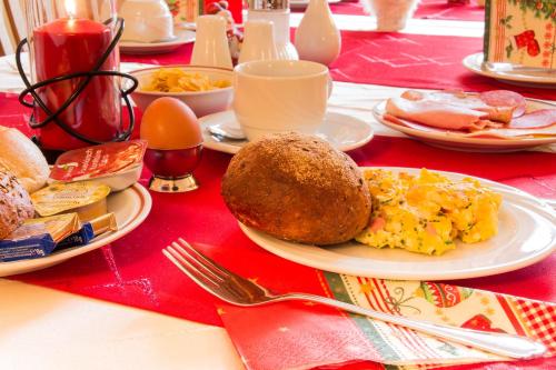a table with plates of food and eggs on it at Hotel zur Post in Wurzen in Wurzen