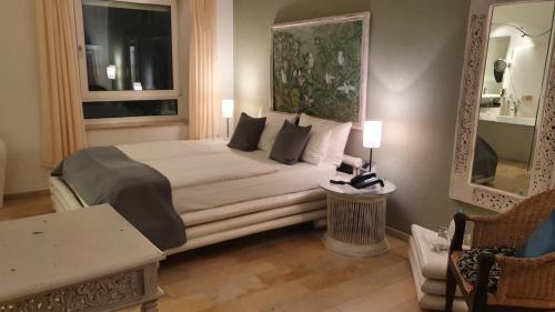 a hotel room with a bed and a mirror at Domaine Leidinger in Saarbrücken
