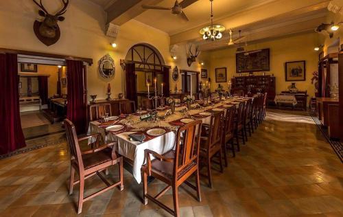 a large dining room with a long table with chairs at Bhanwar Vilas Palace in Karauli
