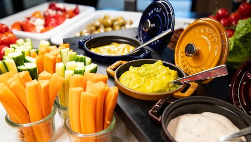 a table topped with different types of vegetables and dip at Hotel Stadtpalais in Cologne