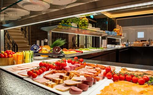 a buffet with many different types of food on display at Hotel Stadtpalais in Cologne