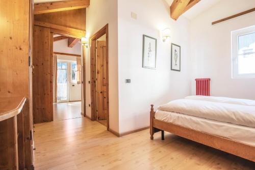a bedroom with a bed in a room with wooden ceilings at Sporting Aparthotel in San Martino di Castrozza