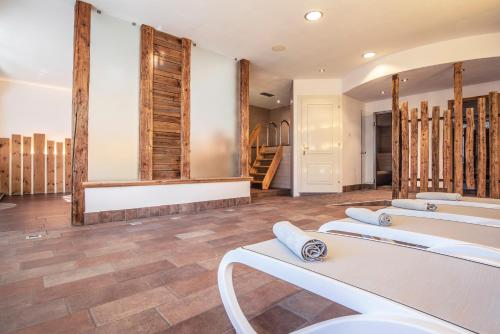 a room with a row of sinks and mirrors at Sporting Aparthotel in San Martino di Castrozza
