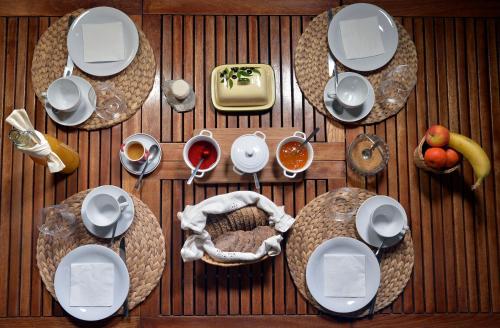 an overhead view of a table with plates and food at Malia - Chambres d'hôtes & Gîte in Barret-de-Lioure
