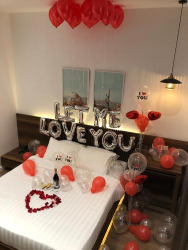 a room with a bed with red balloons and balloons at Coconut Hotel Phú Yên in Tuy Hoa