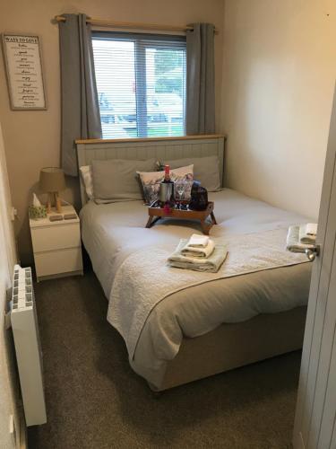 a bedroom with a bed with a table on it at Apartment/Flat 3 in Menai Bridge