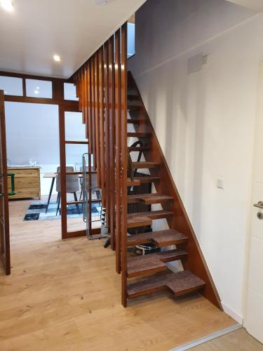 a wooden spiral staircase in a house with a table at Ferienwohnung Steiner 2 in Homburg