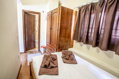 a bedroom with a bed with two towels on it at Kutsinska House in Progled