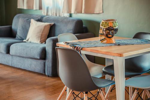 a living room with a table and chairs and a couch at Mansarda Relax Wellness Gym & Spa in Taormina
