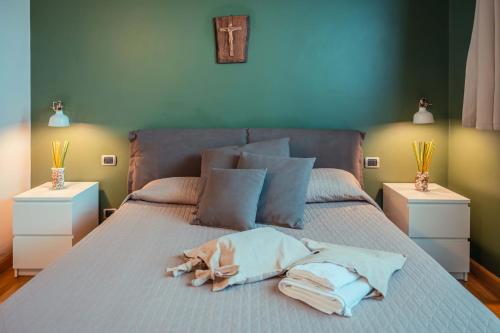 a bed with a pile of towels on it at Mansarda Relax Wellness Gym & Spa in Taormina