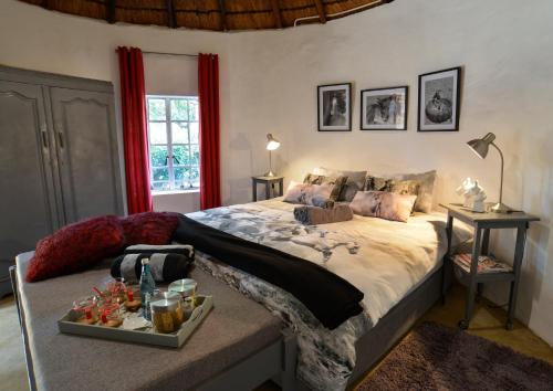 a bedroom with a bed with a tray of food on it at Bridgewaters Horse Park Poolside Rondawel in Hekpoort