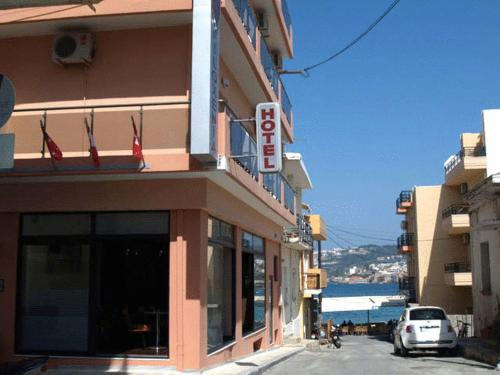 a building with a sign on the side of it at Hotel Filoxenia in Chania Town