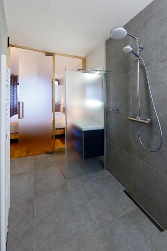 a bathroom with a shower with a glass door at Hotel Wolf in Prague
