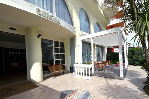 a building with a bench in front of a building at Hotel Europa in Misano Adriatico