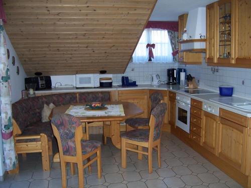 a kitchen with a table and chairs in it at Haus Schmid in Innernzell