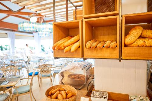 a bakery with lots of breads and pastries on shelves at Seaclub Alcudia Mediterranean Resort in Port d'Alcudia