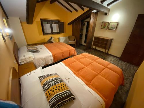 2 camas en una habitación de hotel con 2 camas en Viviendas Rurales la Fragua, en Aliezo
