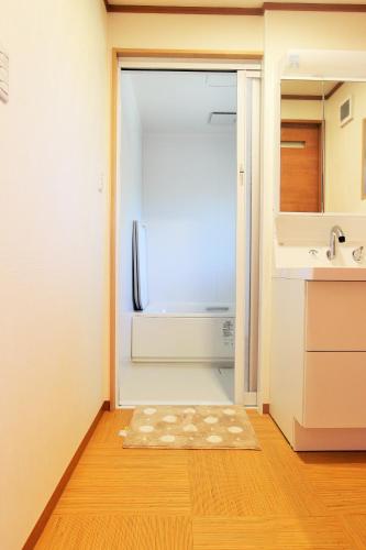 an empty kitchen with a refrigerator in a kitchen at Yadokari Kumano in Kumano