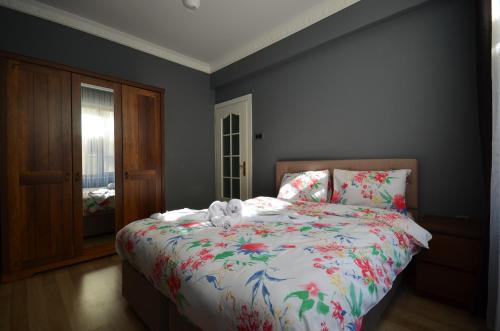 a bedroom with a bed with a stuffed animal on it at Two Minutes To Galata Tower in Istanbul