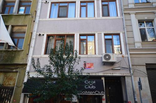 a building with a sign on the side of it at Two Minutes To Galata Tower in Istanbul