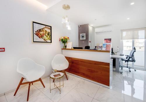 a dental office with two chairs and a counter at South Wind Guesthouse in Marsaxlokk