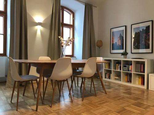 a dining room with a wooden table and chairs at Apartments near Rathaus in Vienna