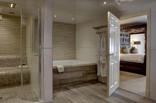 a master bathroom with a tub and a shower at Best Western Premier Doncaster Mount Pleasant Hotel in Doncaster