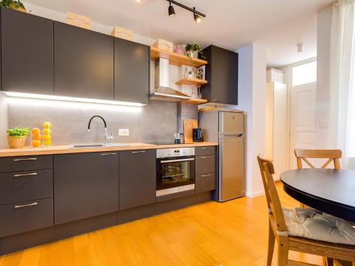 a kitchen with stainless steel appliances and a table at Bella Vista Premium Apartment in Poreč