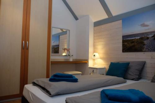 a bedroom with two beds with blue towels on them at Ferienhaus Steffi in Kirchheim
