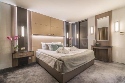 a bedroom with a large bed in a room at Hotel Zena Beauty & Shopping Center in Hévíz