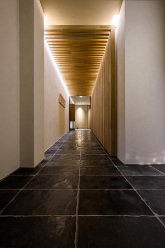 a hallway of a building with a wooden ceiling at HOTEL WOOD TAKAYAMA in Takayama