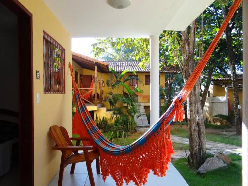 a hammock on the porch of a house at Pousada Cavalo Marinho in Pipa
