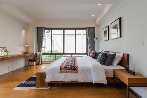 a bedroom with a large bed and a large window at APT476 in Bangkok