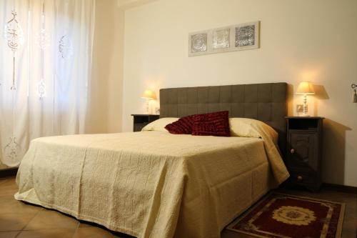 a bedroom with a bed and two lamps and a window at Agriturismo Verbena in Castiglione del Lago