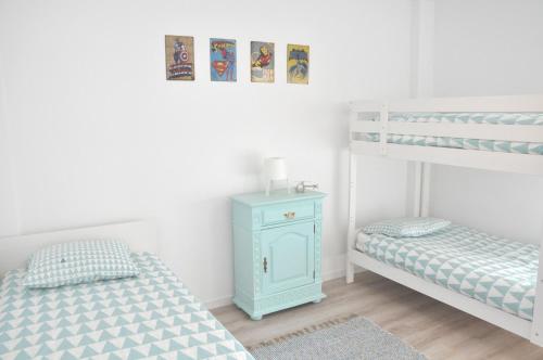 um quarto com 2 beliches e um armário azul em Cascais Family & Friends em Cascais