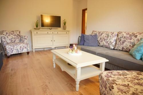 a living room with a couch and a table at Haus zur Sonne in Bad Bertrich