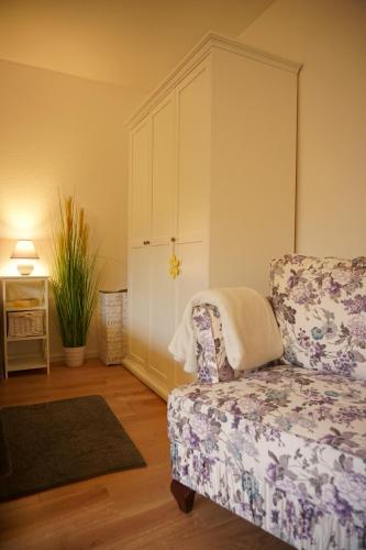 a living room with a couch and a chair at Haus zur Sonne in Bad Bertrich