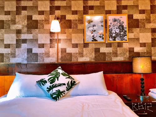 a bed with two pillows on it in a room at Sun Moon Heart Hostel in Puli