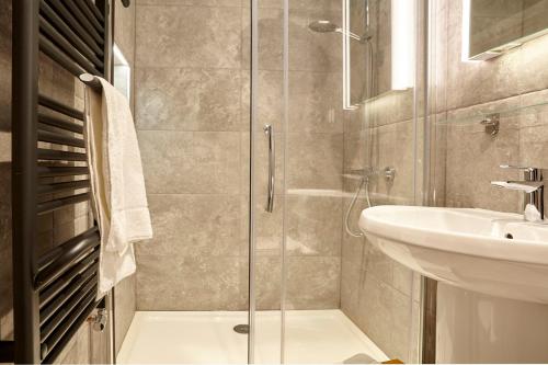 a bathroom with a shower and a sink at The Mural - City Centre - Your Apartment in Bristol