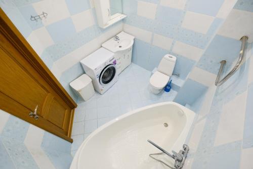 a bathroom with a toilet and a bath tub at ОК! Никитина, 20 №2 in Tomsk