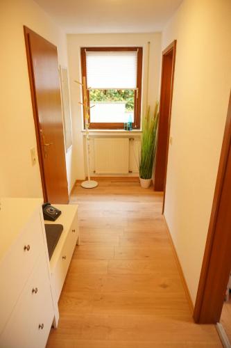 an empty kitchen with a window and a wooden floor at Haus zur Sonne in Bad Bertrich