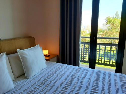 a bedroom with a bed and a large window at Barceló Cornellà in Cornellà de Llobregat