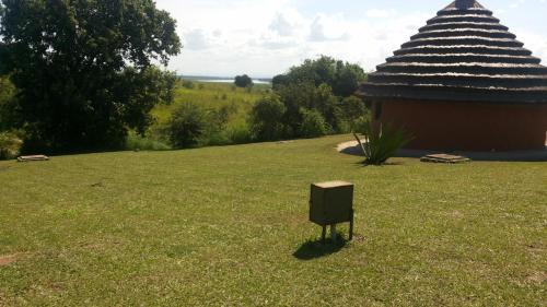a box in the grass next to a building at Heritage Safari Lodge in Pakwach East