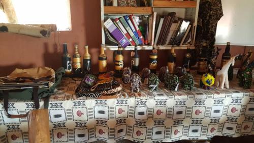 a table topped with lots of vases on top at Heritage Safari Lodge in Pakwach East