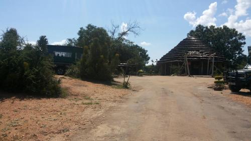 a dirt road in front of a building at Heritage Safari Lodge in Pakwach East