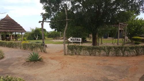 a street sign in a park with a playground at Heritage Safari Lodge in Pakwach East