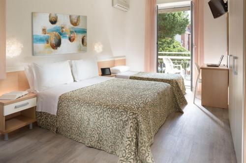 A bed or beds in a room at Hotel Bassetti