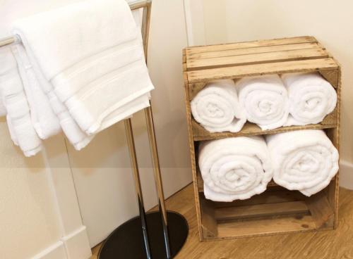 a bundle of towels on a rack in a bathroom at Croft House, Armadale Bay in Armadale