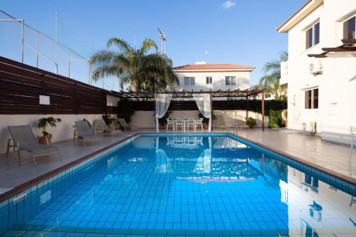 a swimming pool with blue tiles in a building at Athena Villa in Ayia Napa