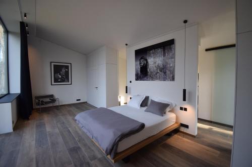 En eller flere senge i et værelse på Le Bouquet d'Arbres